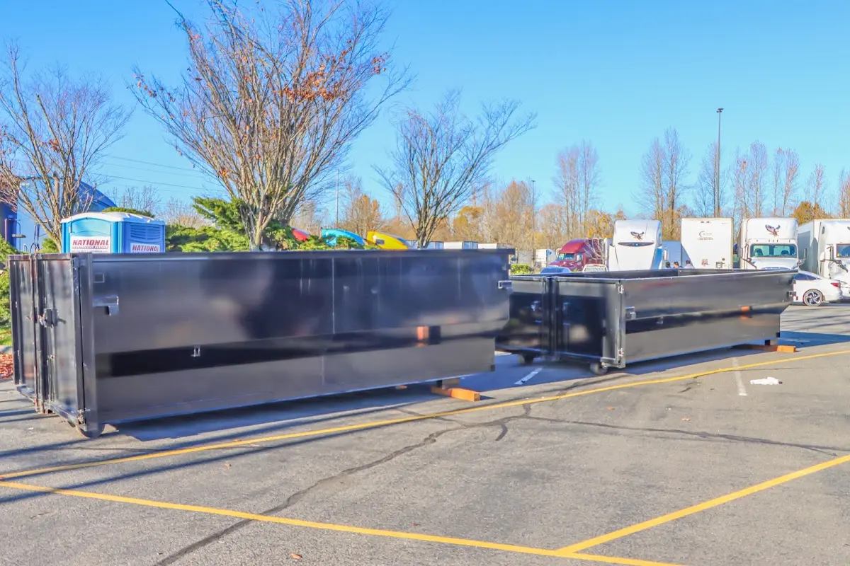 Professional dumpster rental service with roll-off container on residential driveway in Seattle